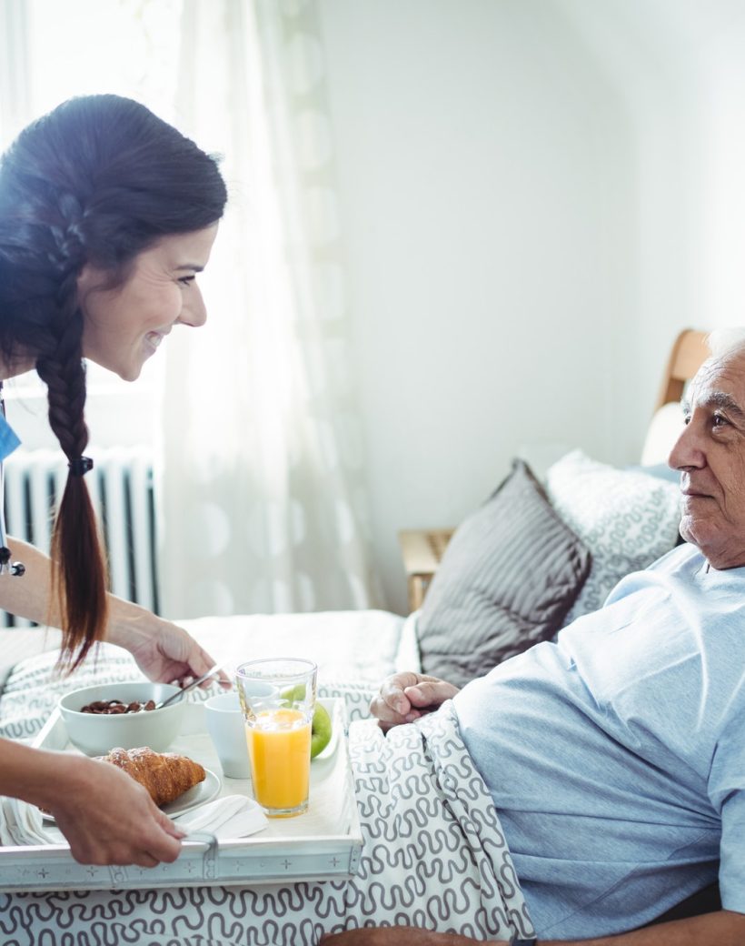 nurse-serving-breakfast-to-senior-man.jpg